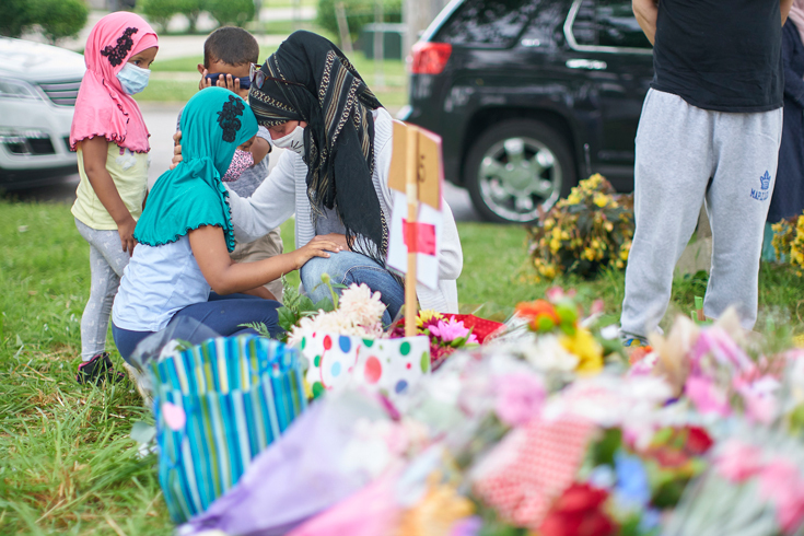 A woman speaks with her daughter at the scene of Sunday's hate-motivated vehicle attack in London, Ontario